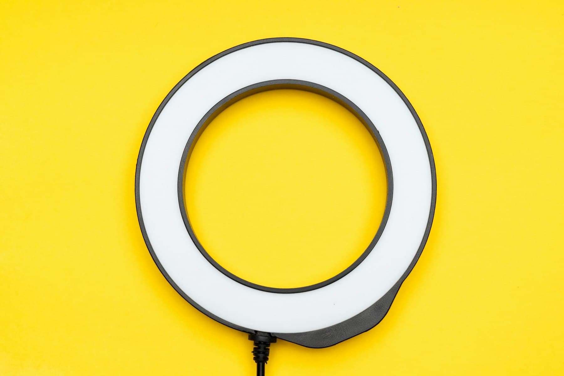 A ring light on a bright yellow background